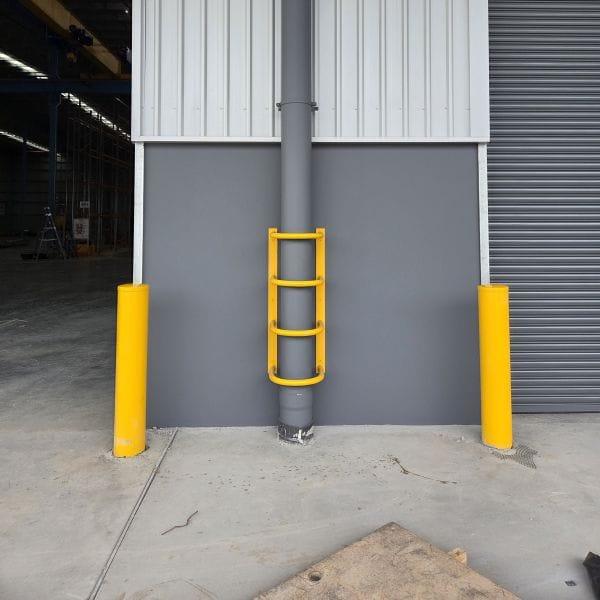 Bollards Steel safety bollards and downpipe guard installed at a warehouse entry