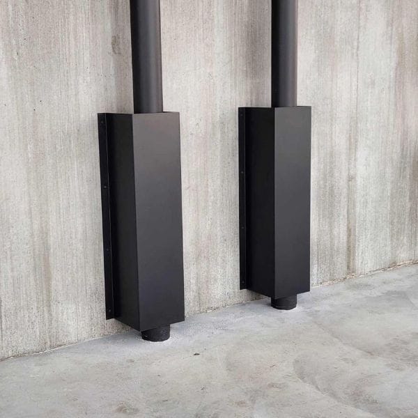 Custom powdercoated downpipe guards - 1-1 Custom powdercoated folded steel downpipe guards installed on a warehouse wall to protect services from vehicle damage